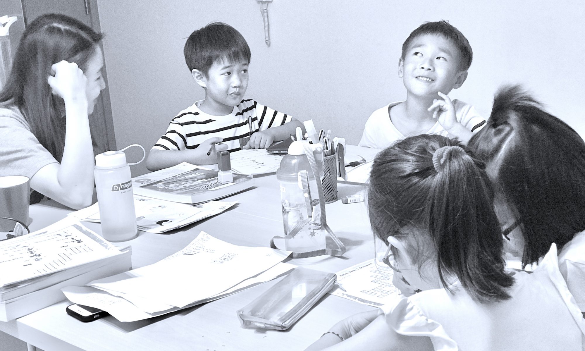 Students considering how to solve a Mathematics question during tuition.