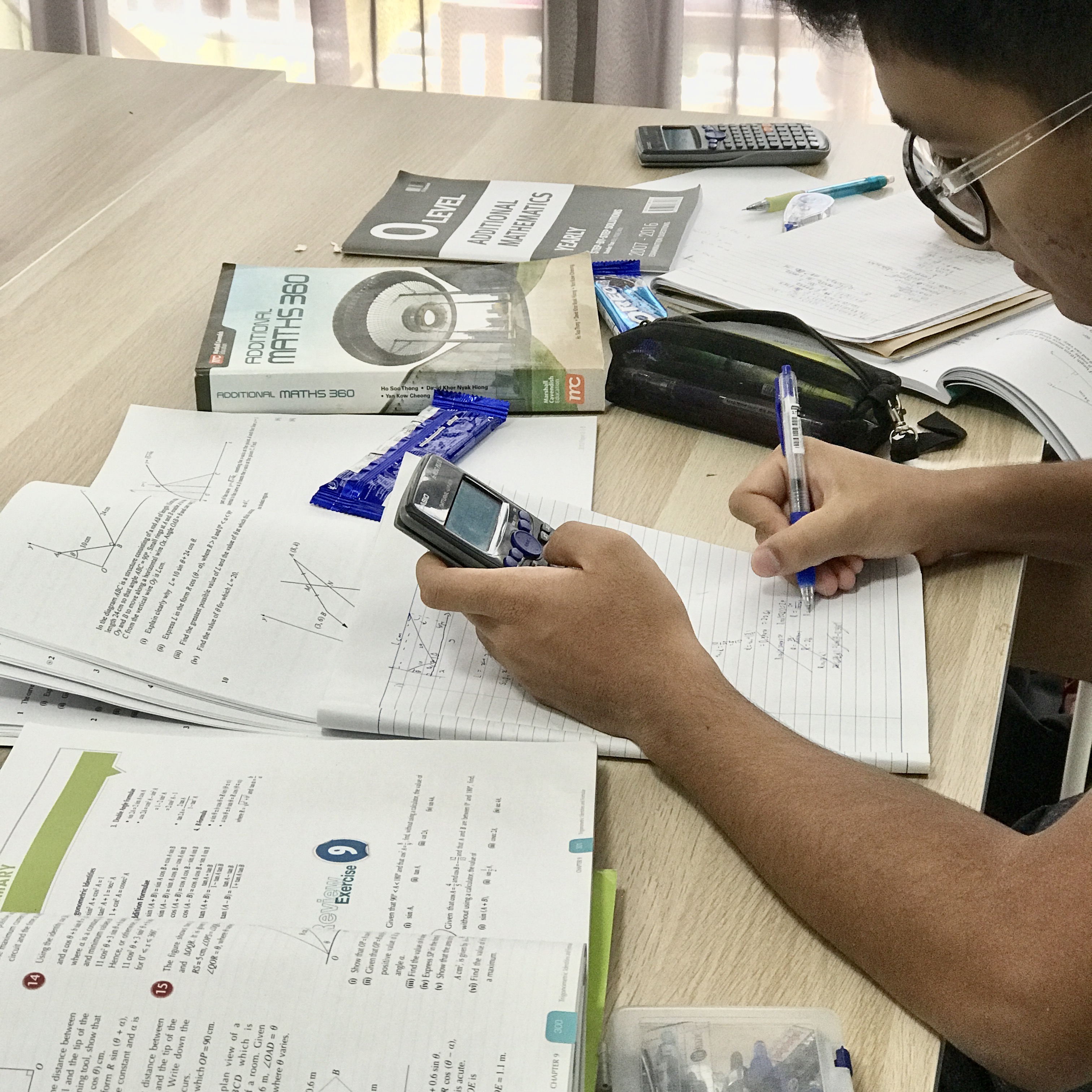 A tutor helping a student review and correct mistakes in classwork.