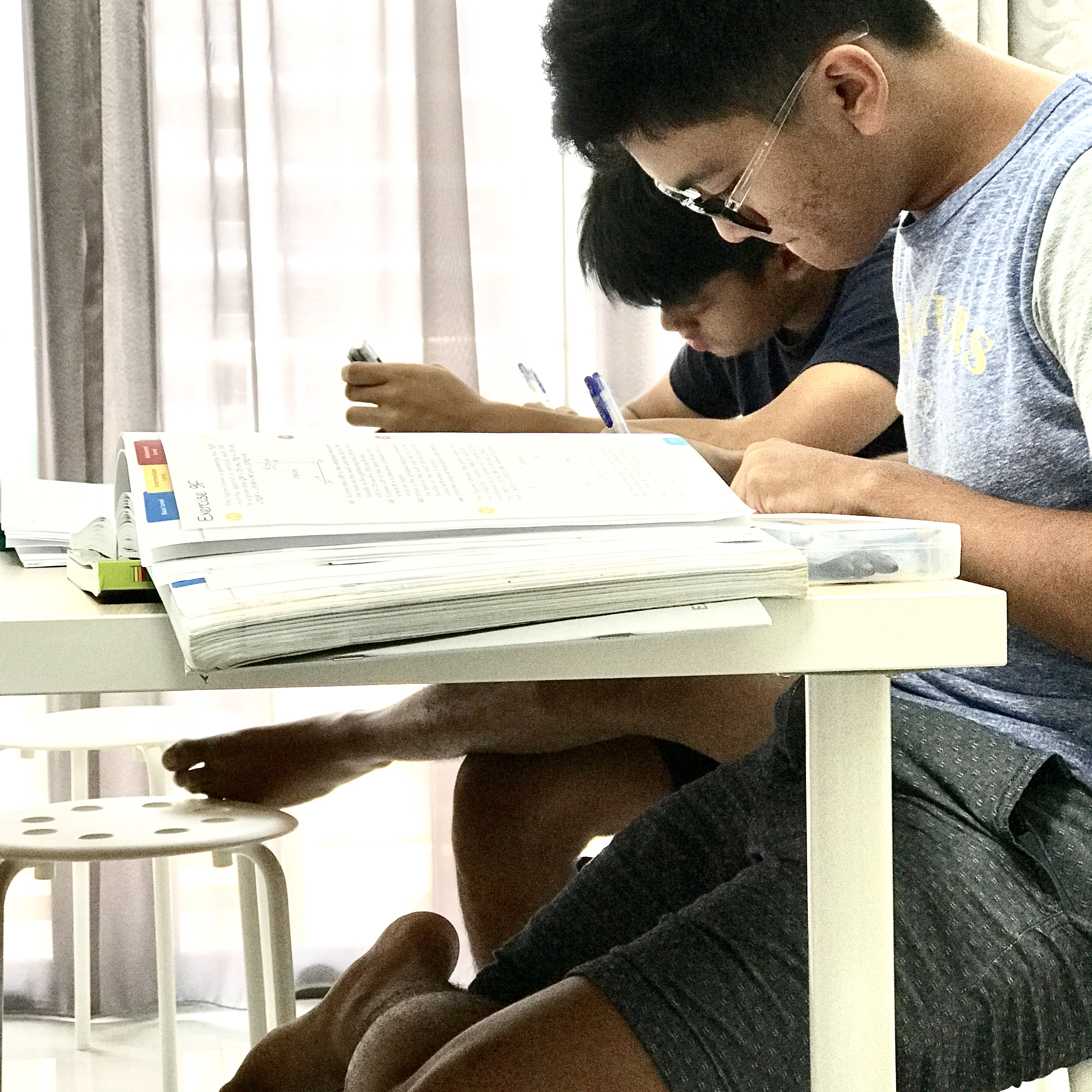 Students preparing for GCE O-Level Additional Mathematics examinations in a tuition class.