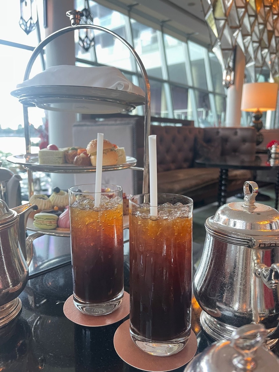 Iced coffee served with a tray of scones and cakes during tea time at The Fullerton Bay Hotel Singapore.