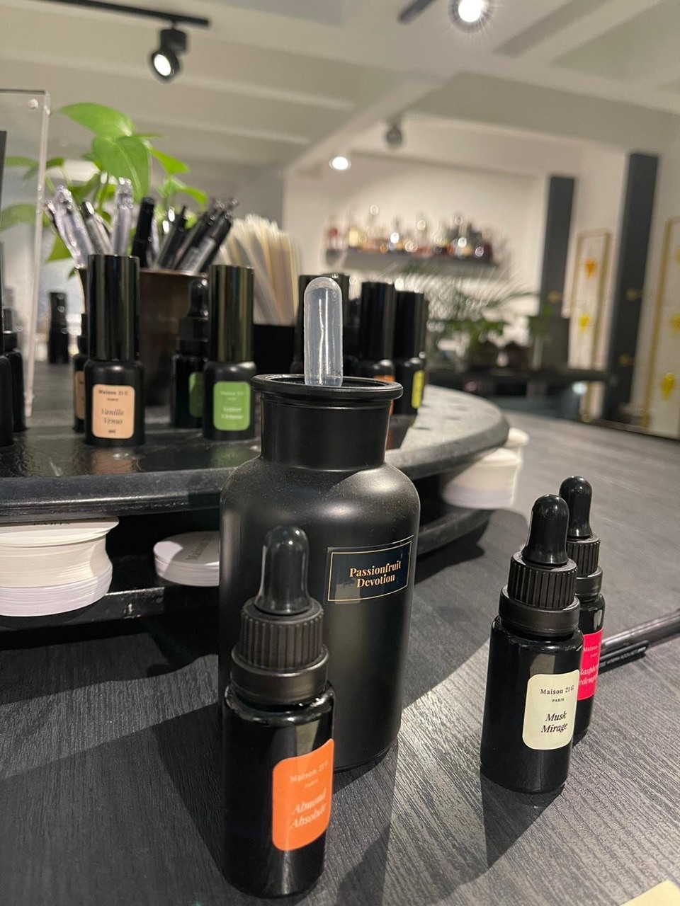 Fragrance ingredients and equipment at a perfumery mixing station.
