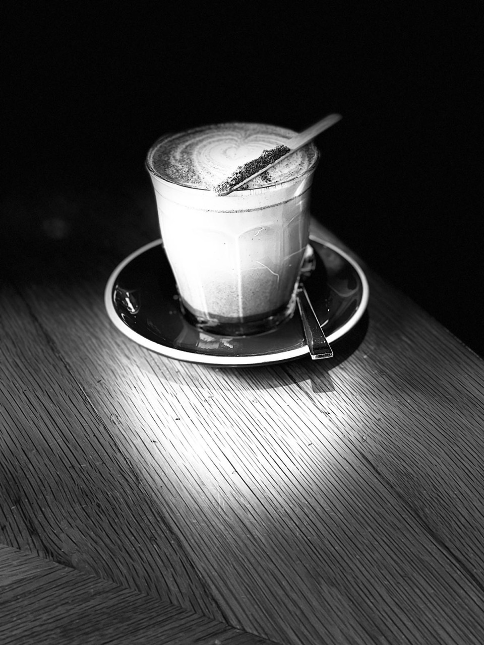 Artistic monochrome photograph of a latte.