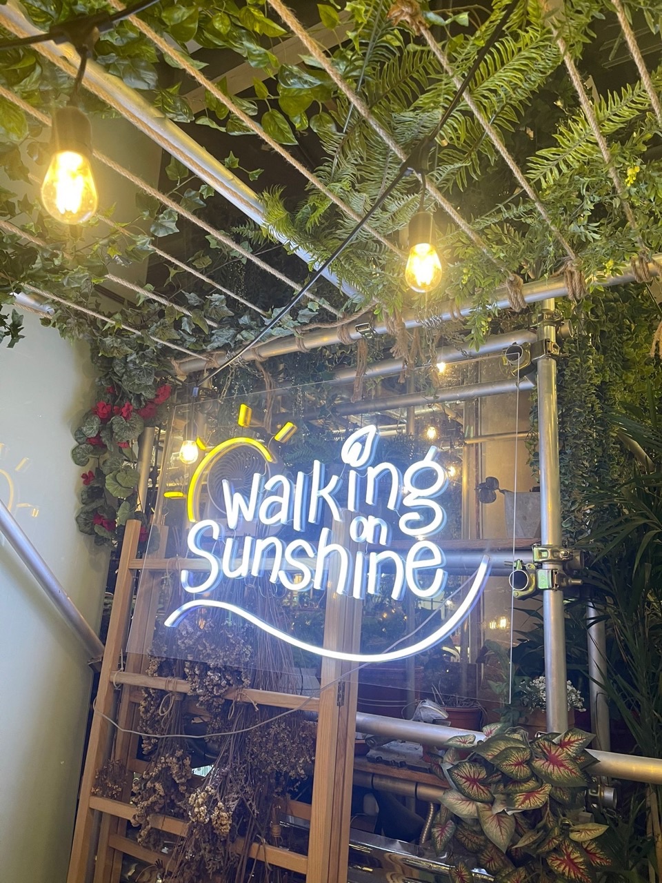 Restaurant signage and decoration featuring the words Walking on Sunshine.