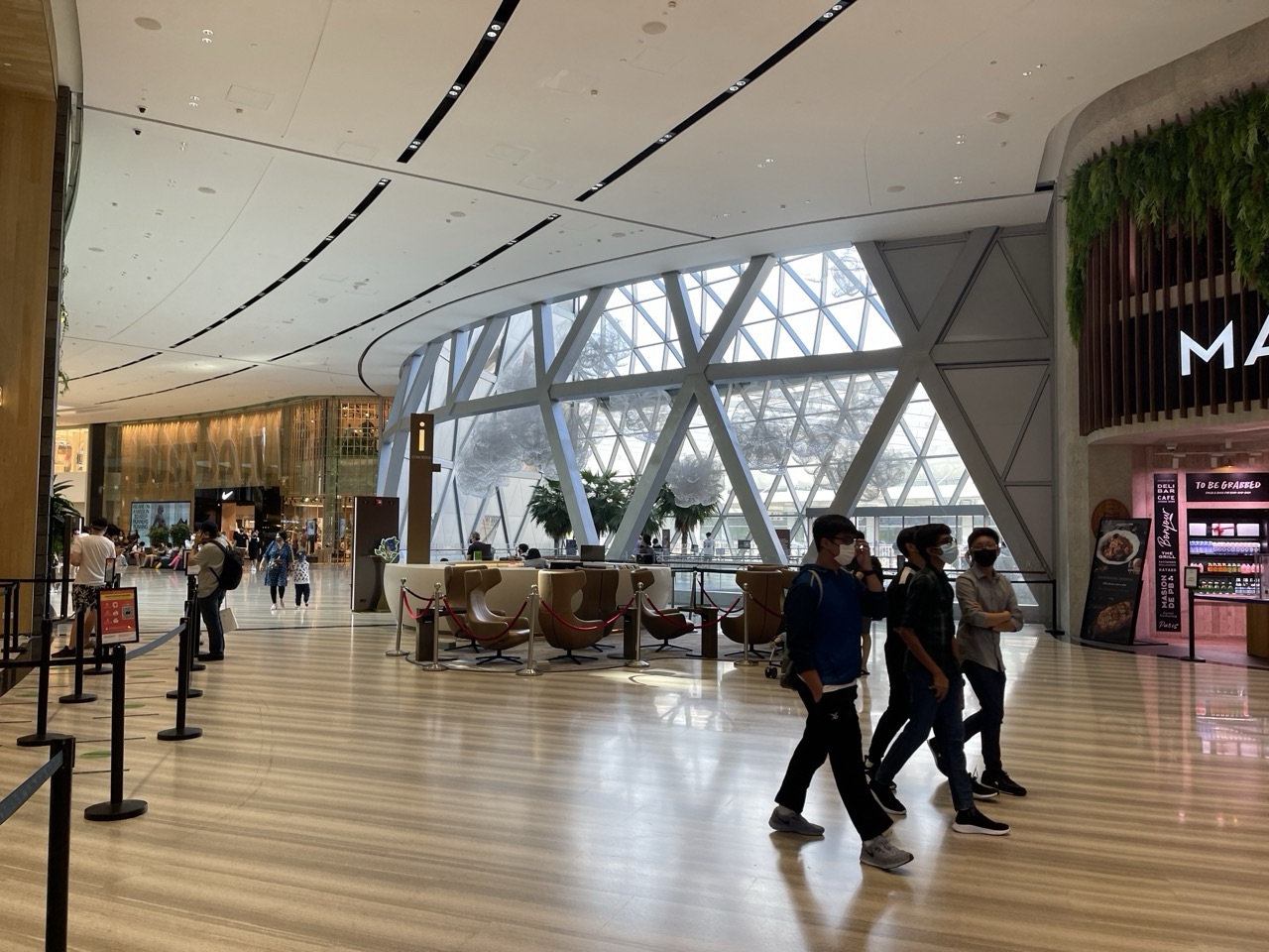 Interior walkway at Jewel Changi Airport with pedestrians.
