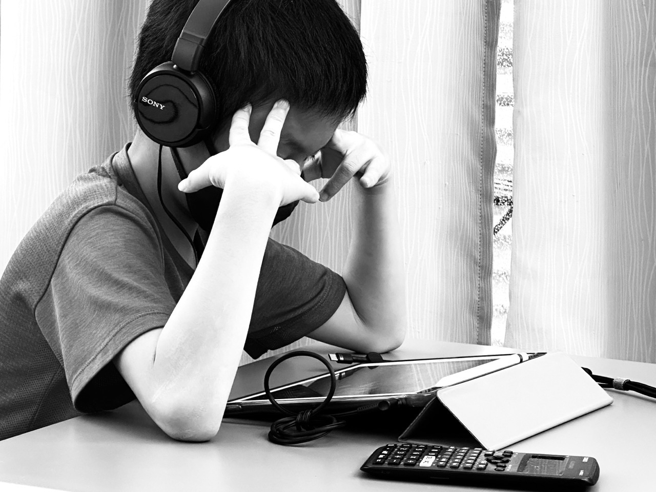 Student using an iPad while listening to study instructions.