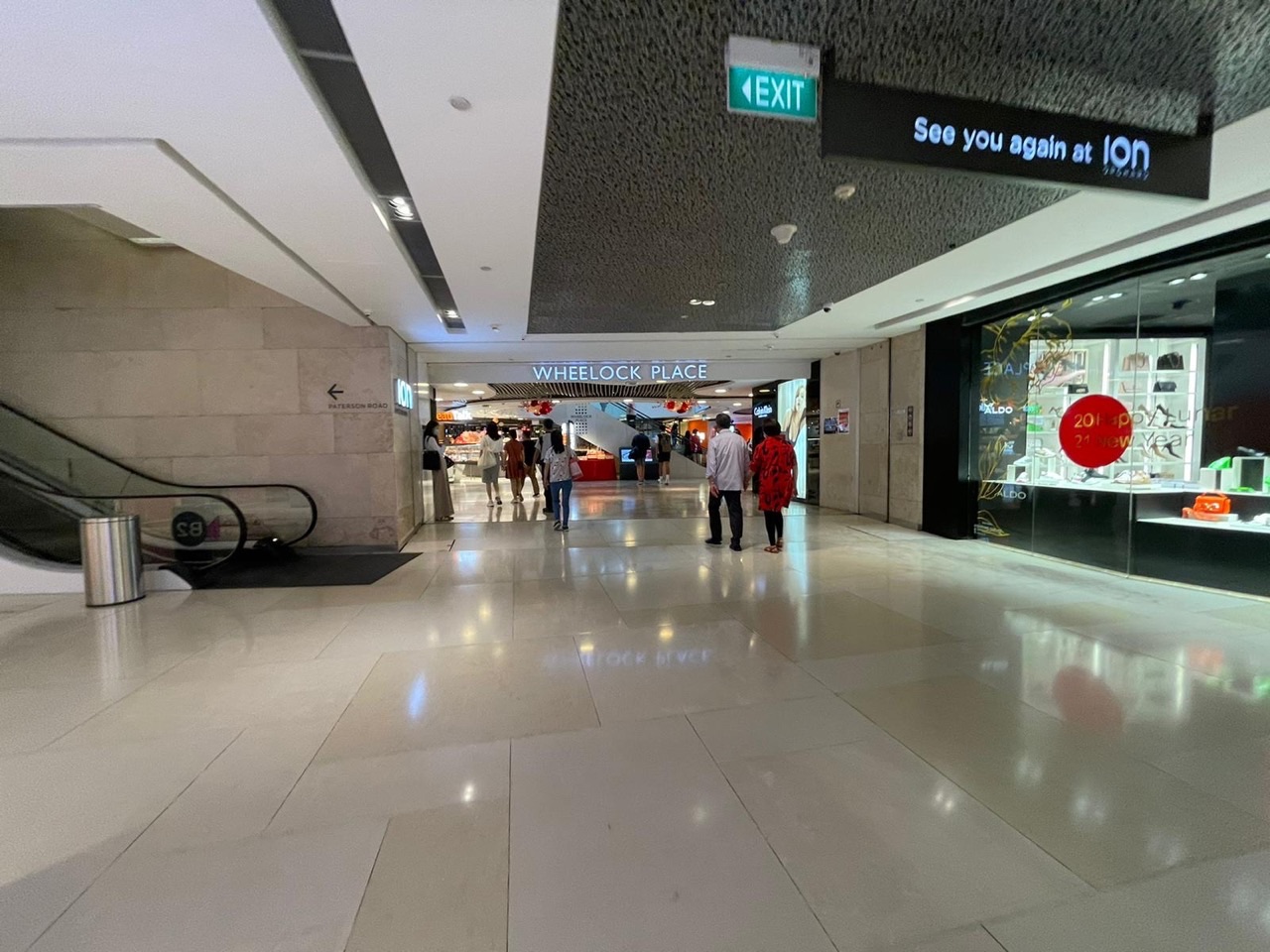 Shoppers walking through the underground link between ION Orchard and Wheelock Place in Singapore.