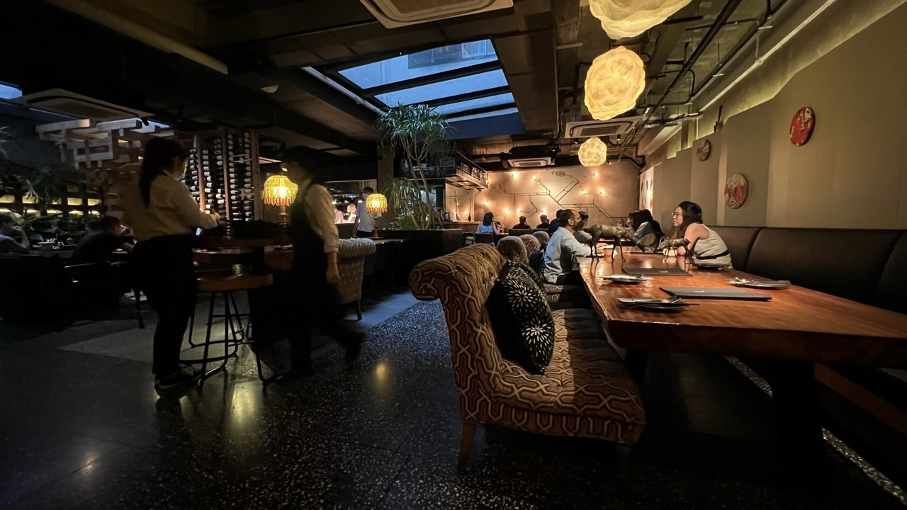 Interior of a Singapore restaurant with diners and serving staff.