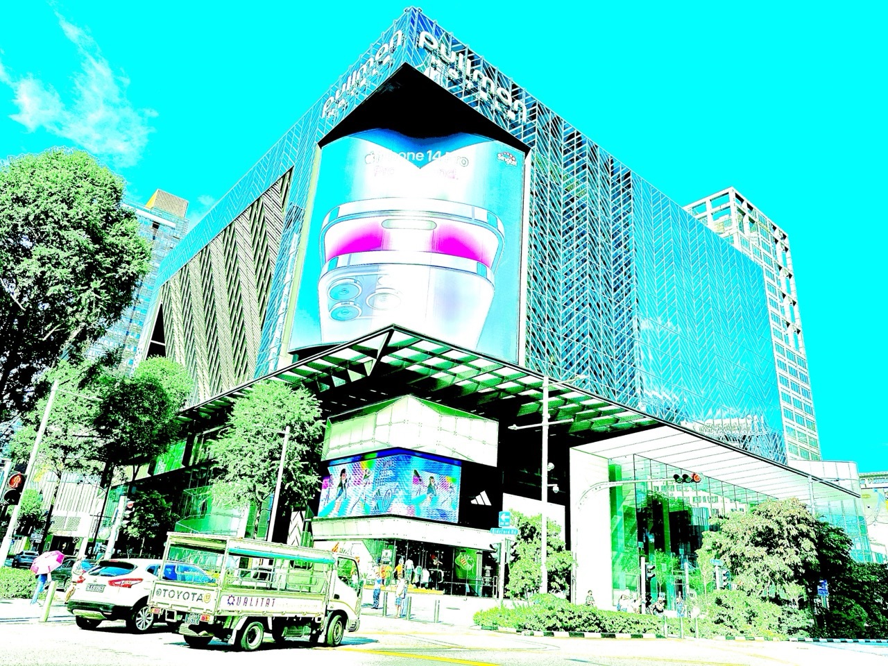 Pullman Singapore Orchard with a truck and car at a traffic-light crossing.
