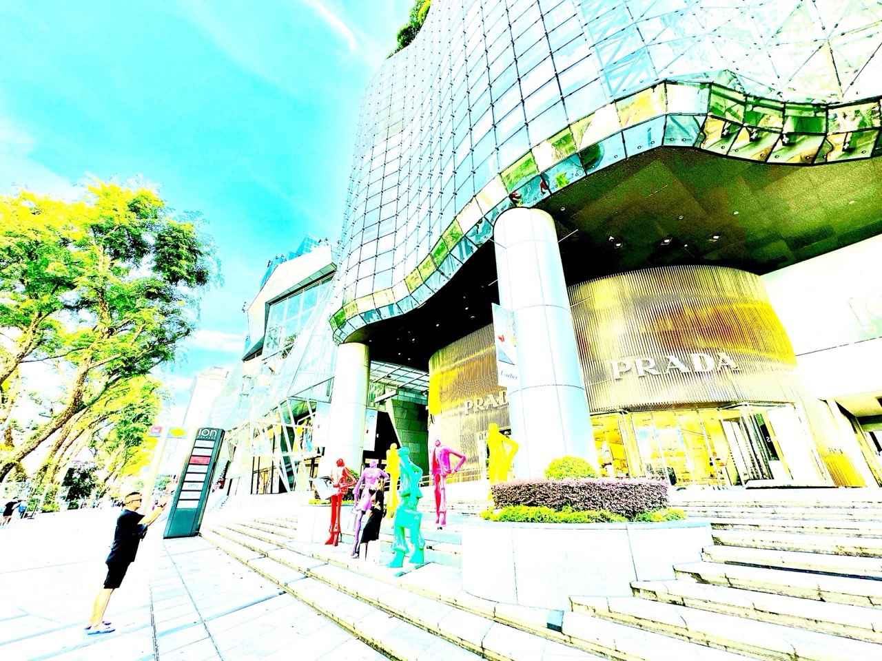 Person taking a photograph of an art installation at ION Orchard in Singapore.