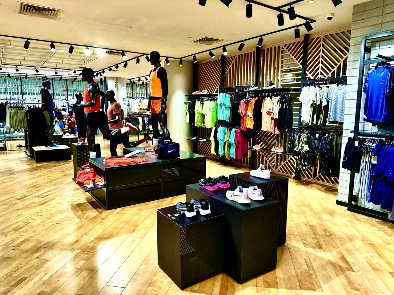 Sportswear shop displaying clothing and shoes.