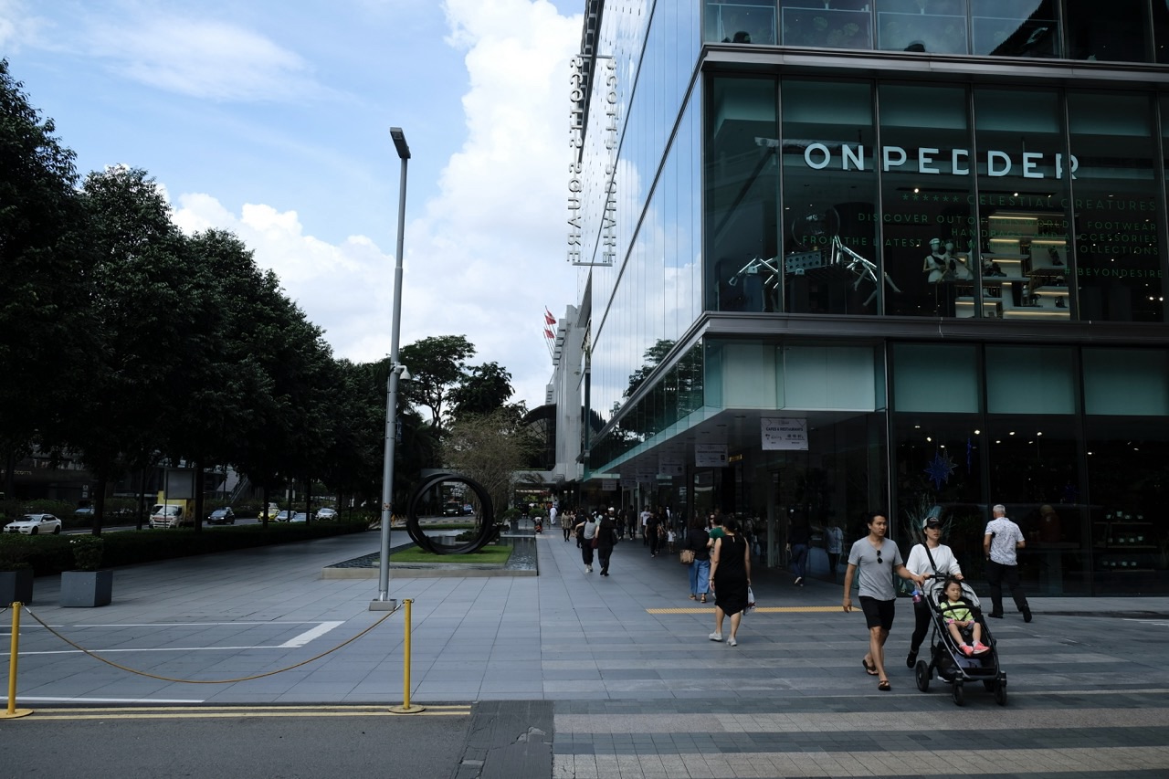 Scotts Square exterior with pedestrians and a family with a stroller.