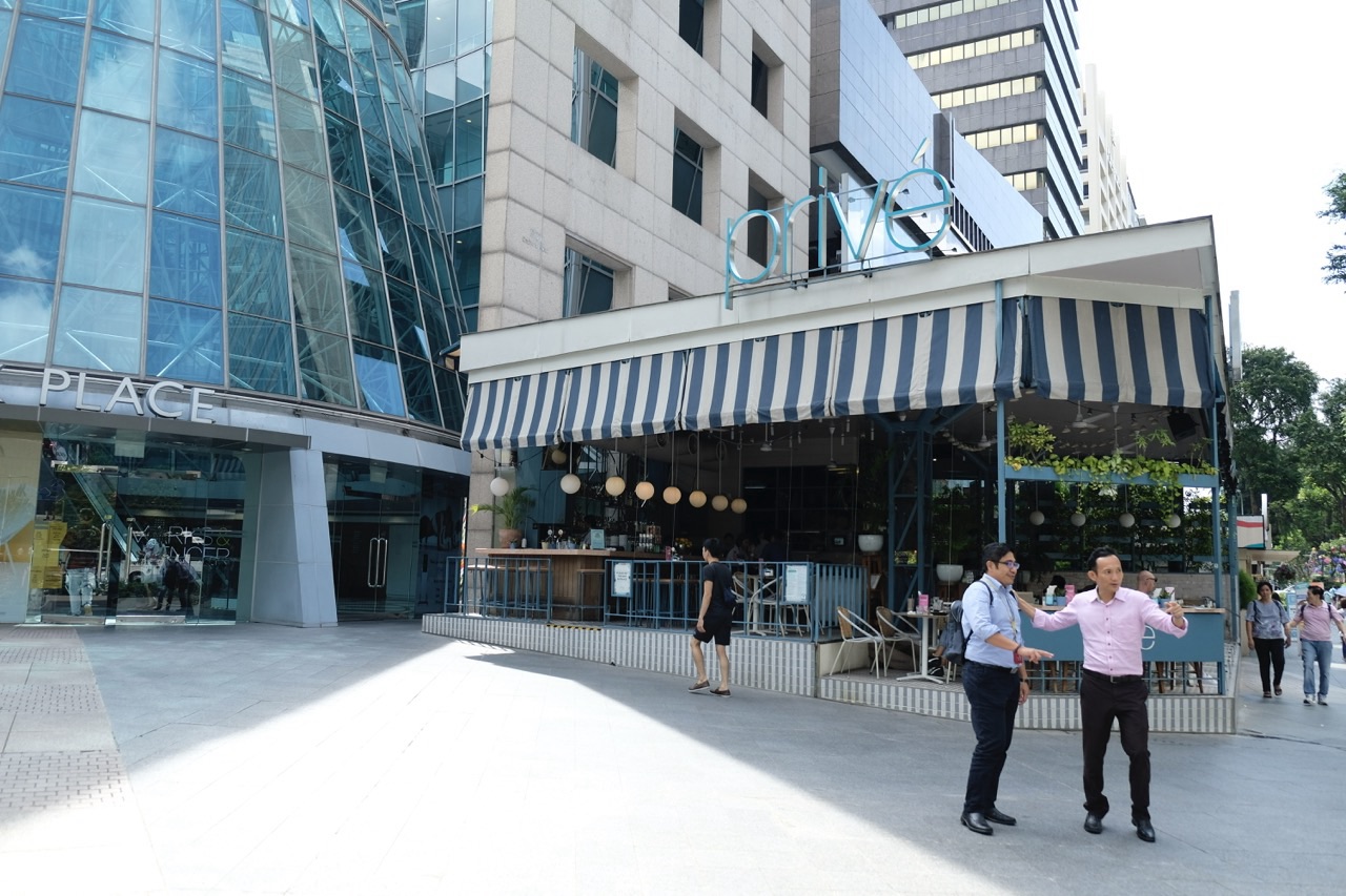 Wheelock Place exterior with a café along the Orchard Road streetscape.