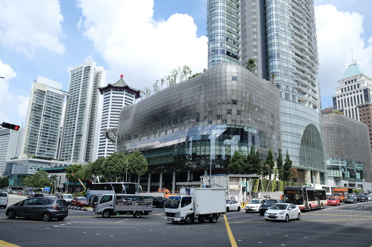 Intersection between ION Orchard and TANGS with road traffic in Singapore.