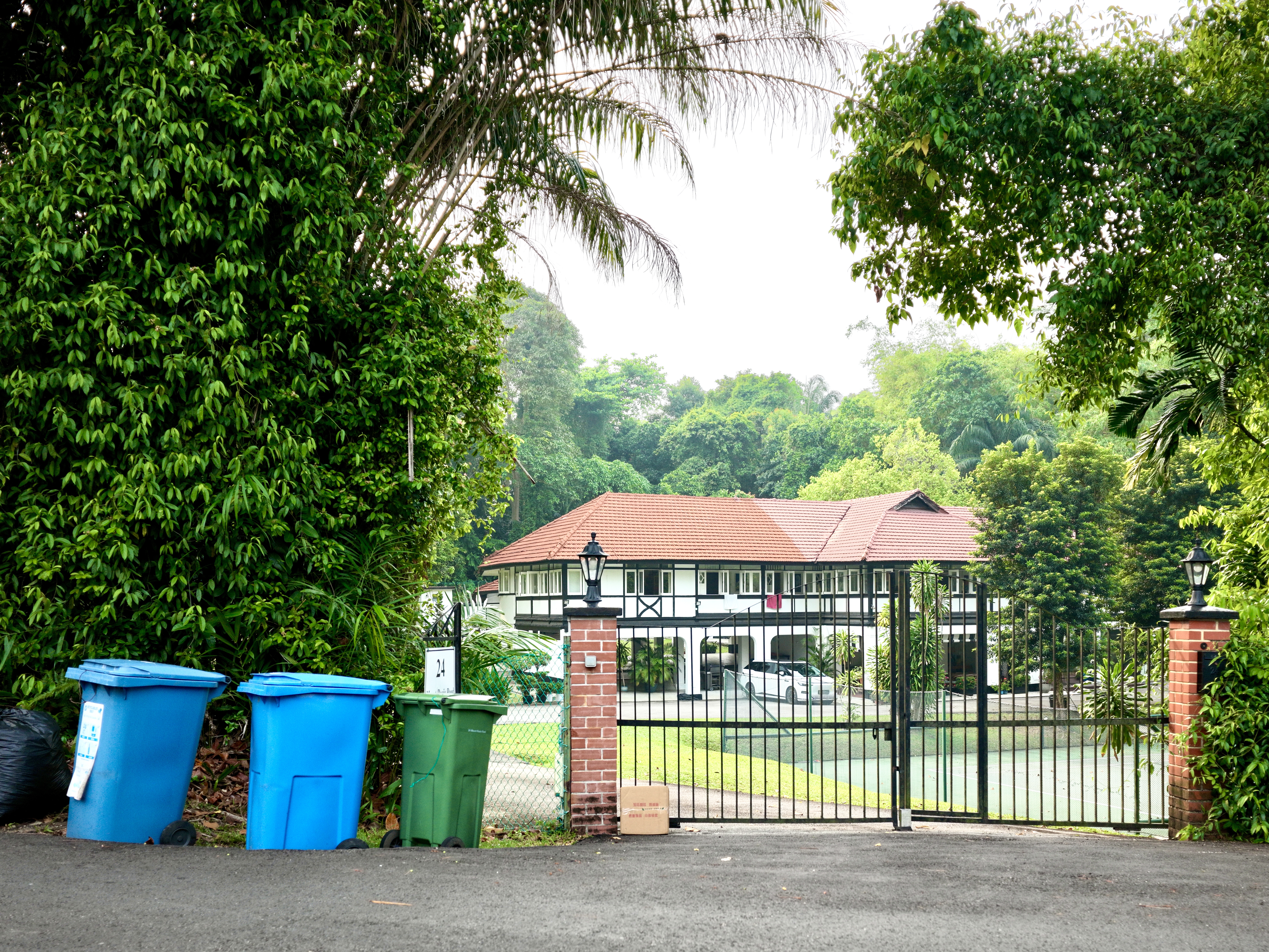 Black-and-white bungalow at Mount Rosie in Singapore with a tennis court.
