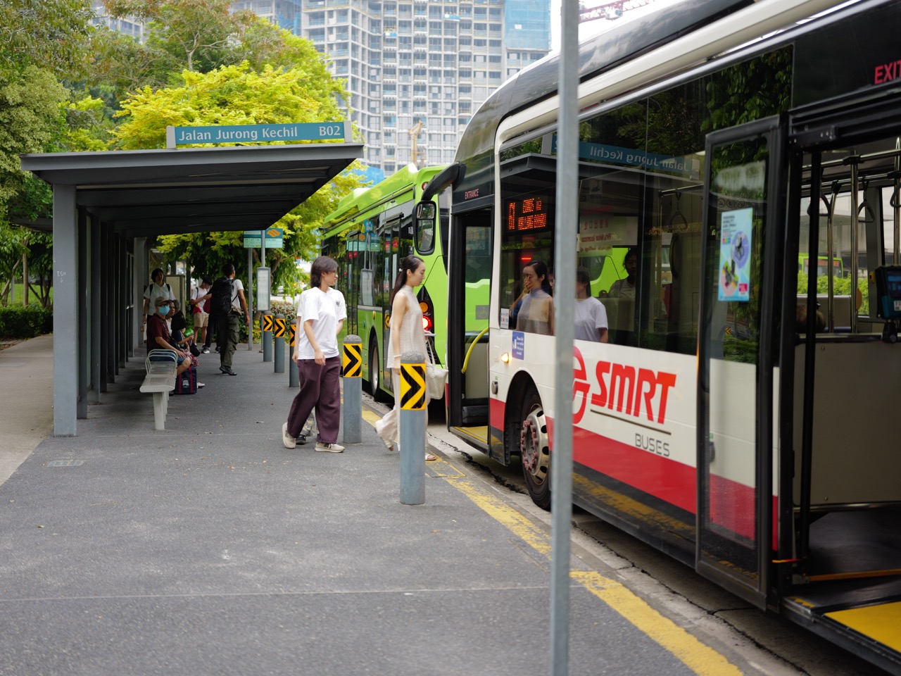 Bus stop on Jalan Jurong Kechil with passengers and construction in the background.