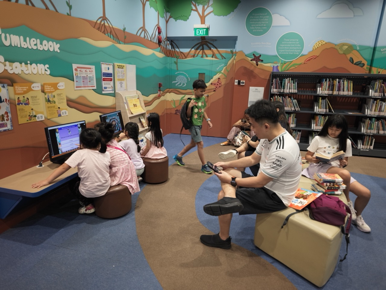 Children's reading and biodiversity section with computer terminals inside the National Library Building in Singapore
