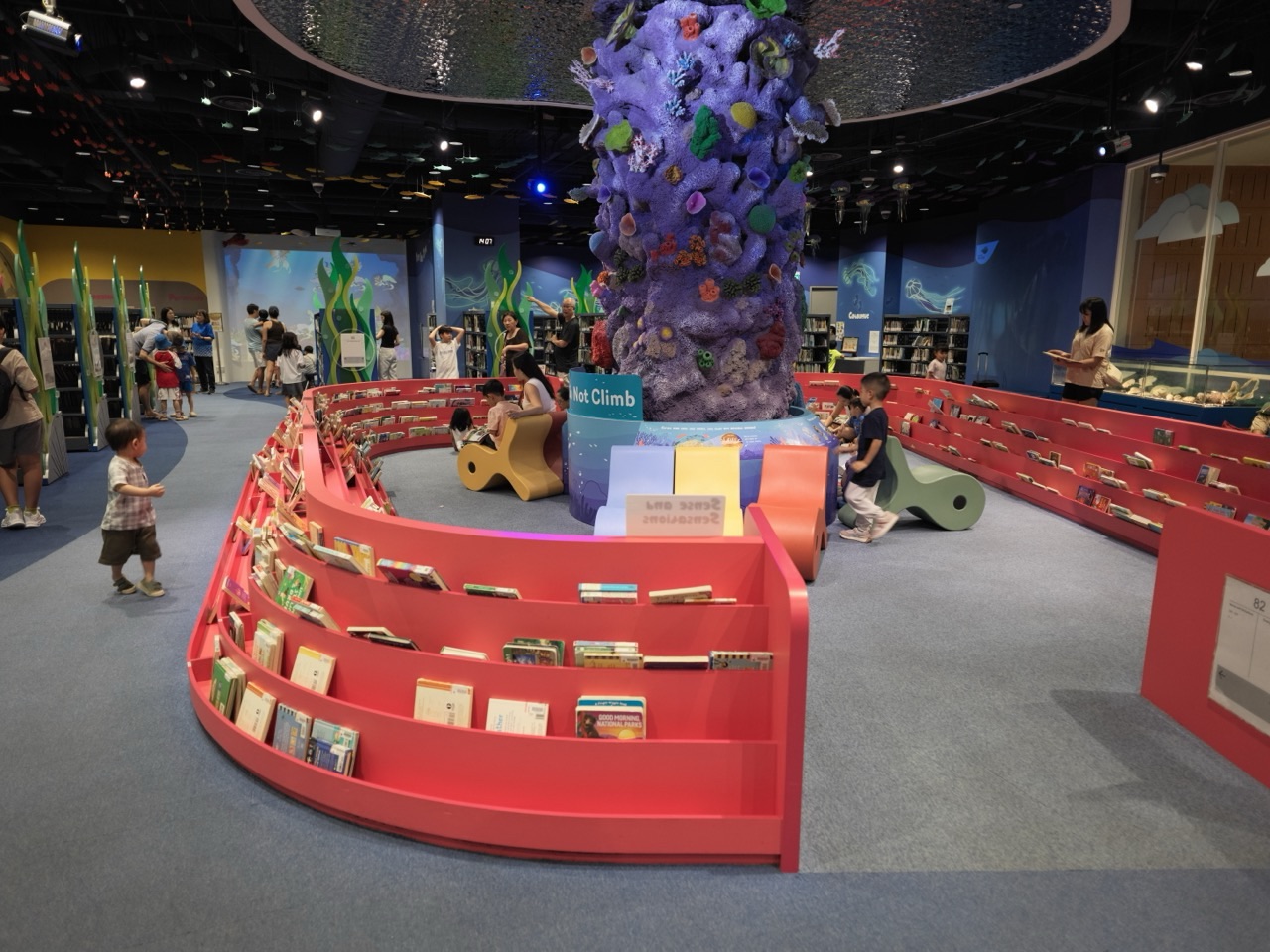 Children reading in the biodiversity section inside the National Library Building in Singapore