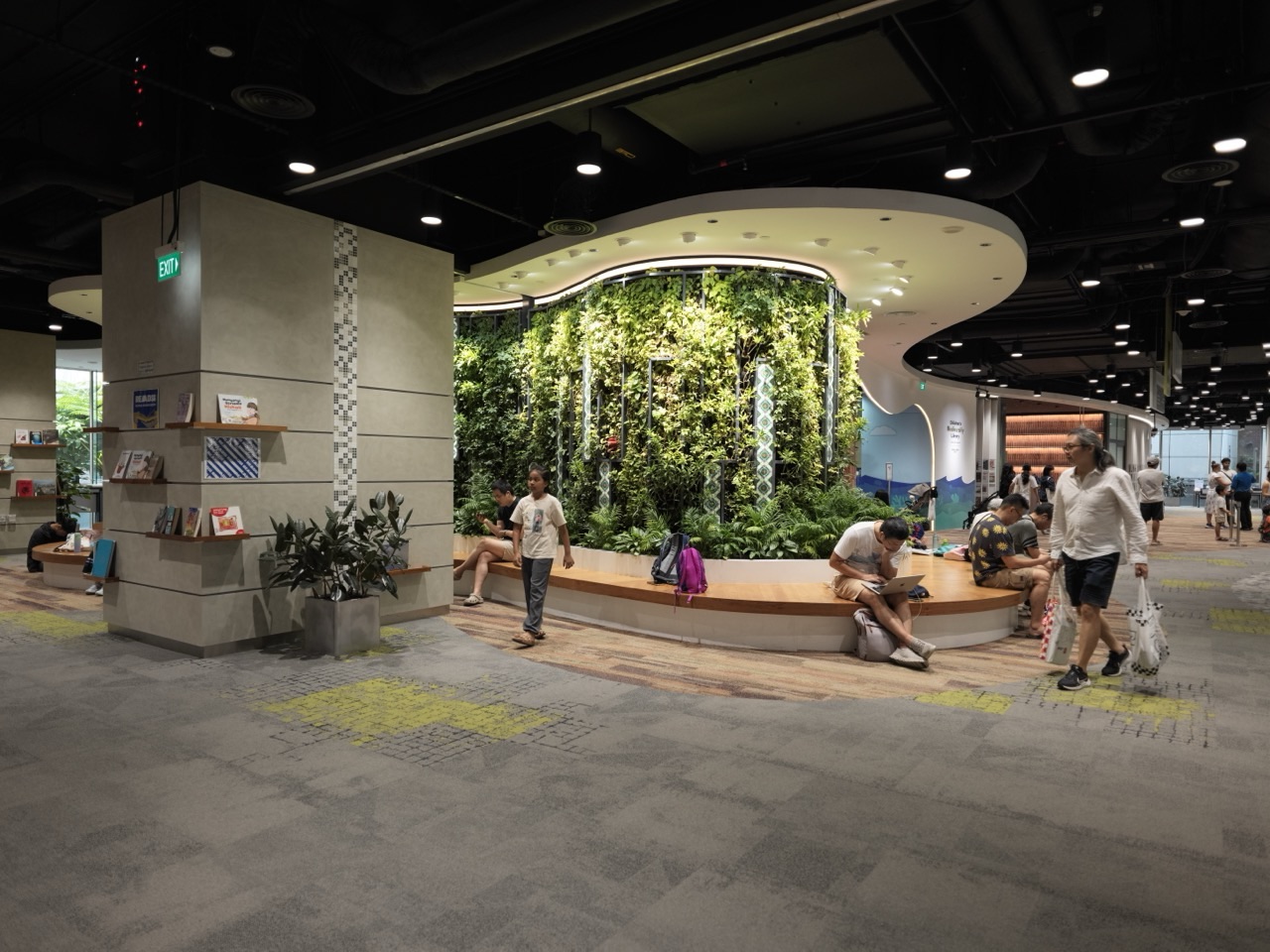 Reading and seating area with display features and interior lighting inside the National Library Building in Singapore