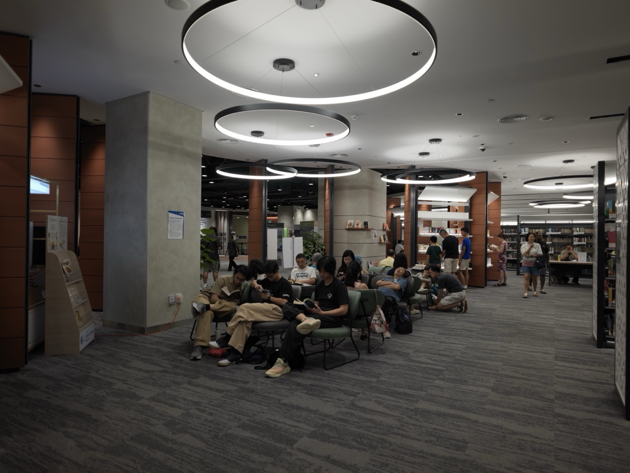Reading, seating and display area with interior lighting inside the National Library Building in Singapore