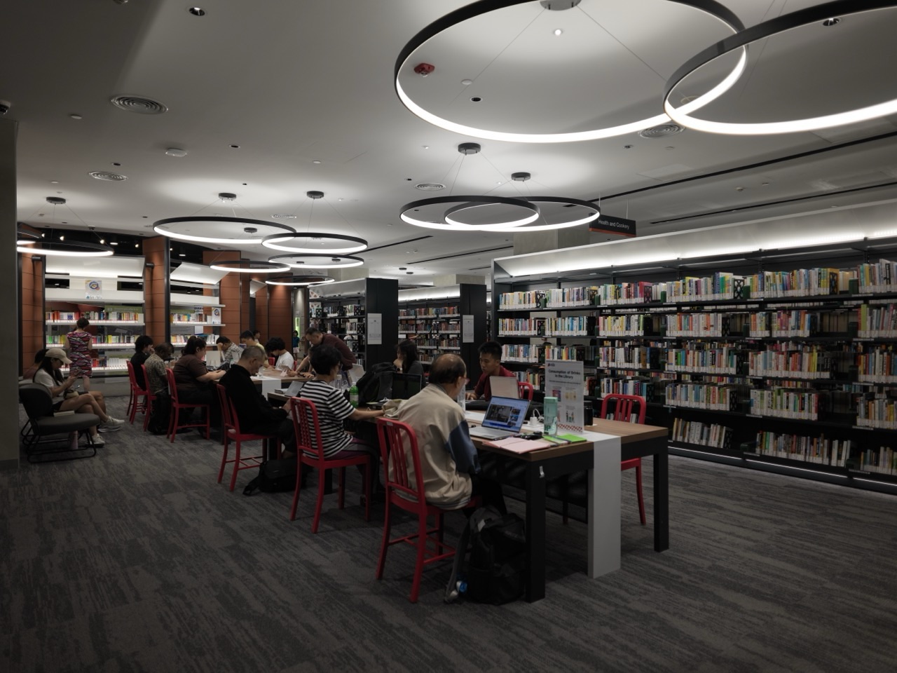 Reading and research tables among bookshelves inside the National Library Building in Singapore
