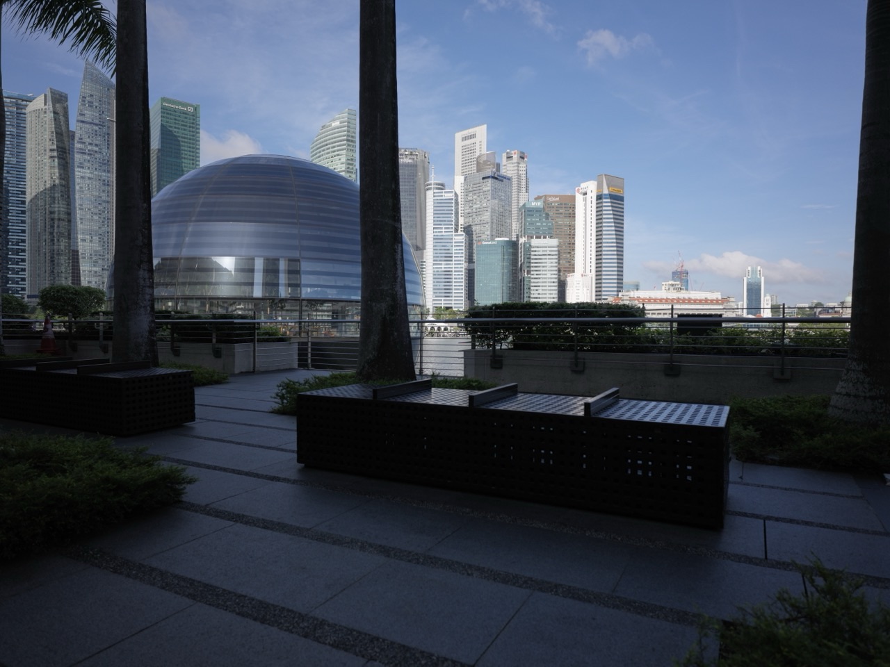 Apple Marina Bay Sands beside the waterfront promenade with the financial district skyline in the background
