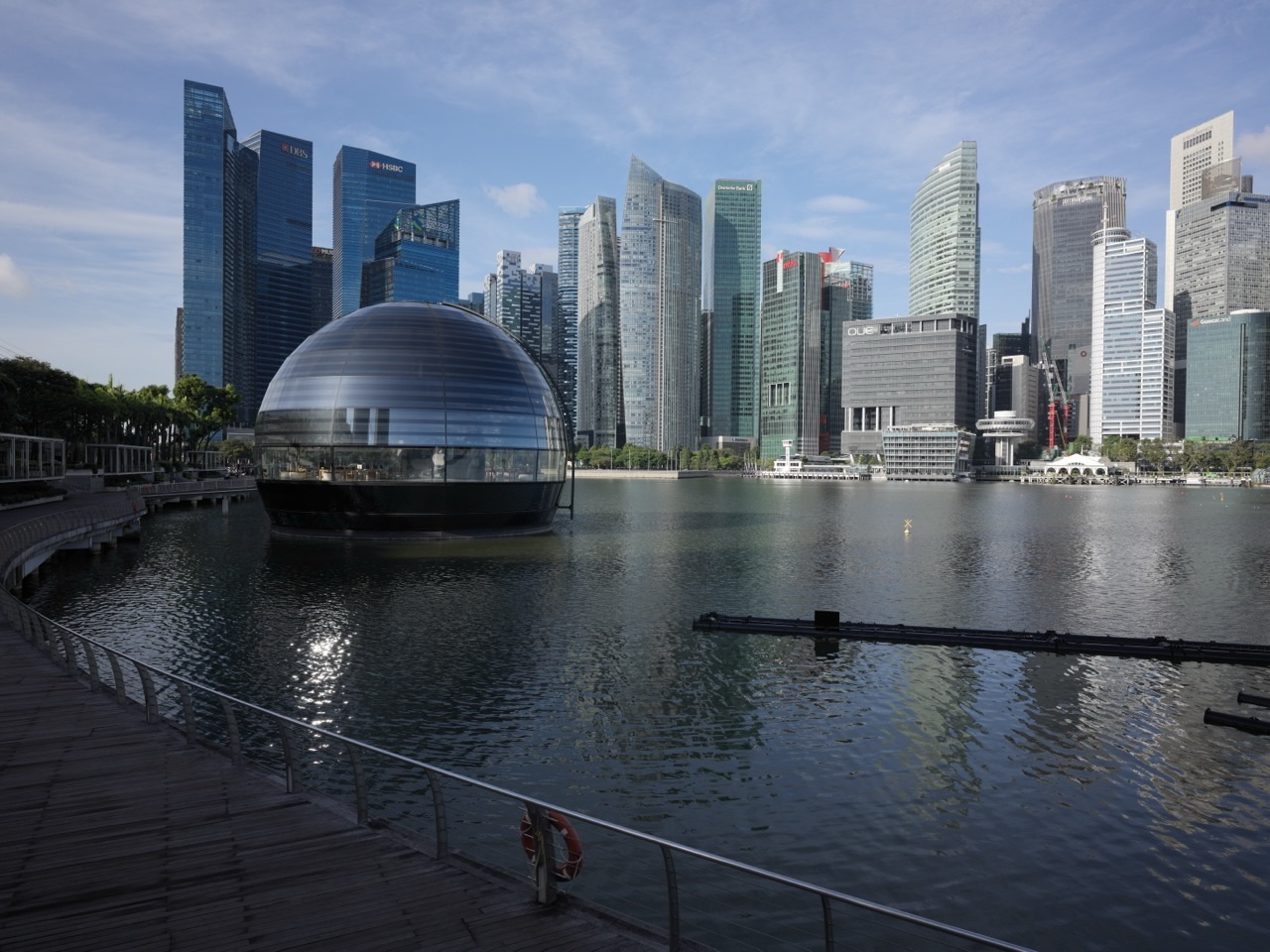 Apple Marina Bay Sands beside the waterfront promenade with the financial district skyline in the background