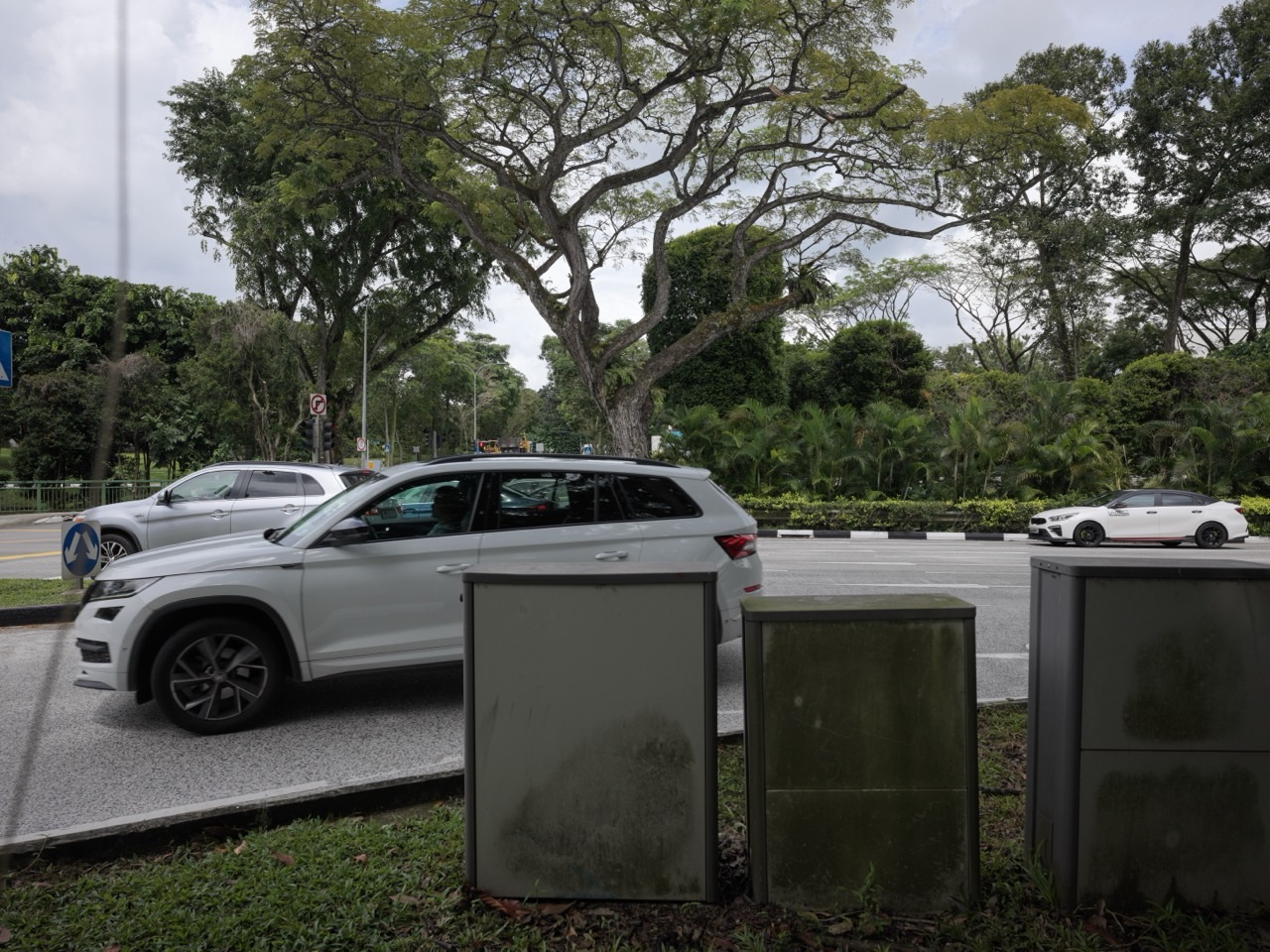 Cars turning from a side road into Sixth Avenue in Bukit Timah, Singapore