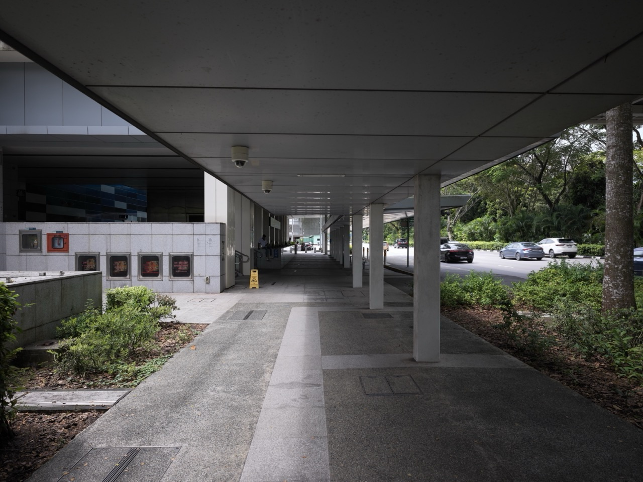 Sheltered walkway linking Sixth Avenue MRT station with the bus stop, pick-up area and nearby residences in Bukit Timah