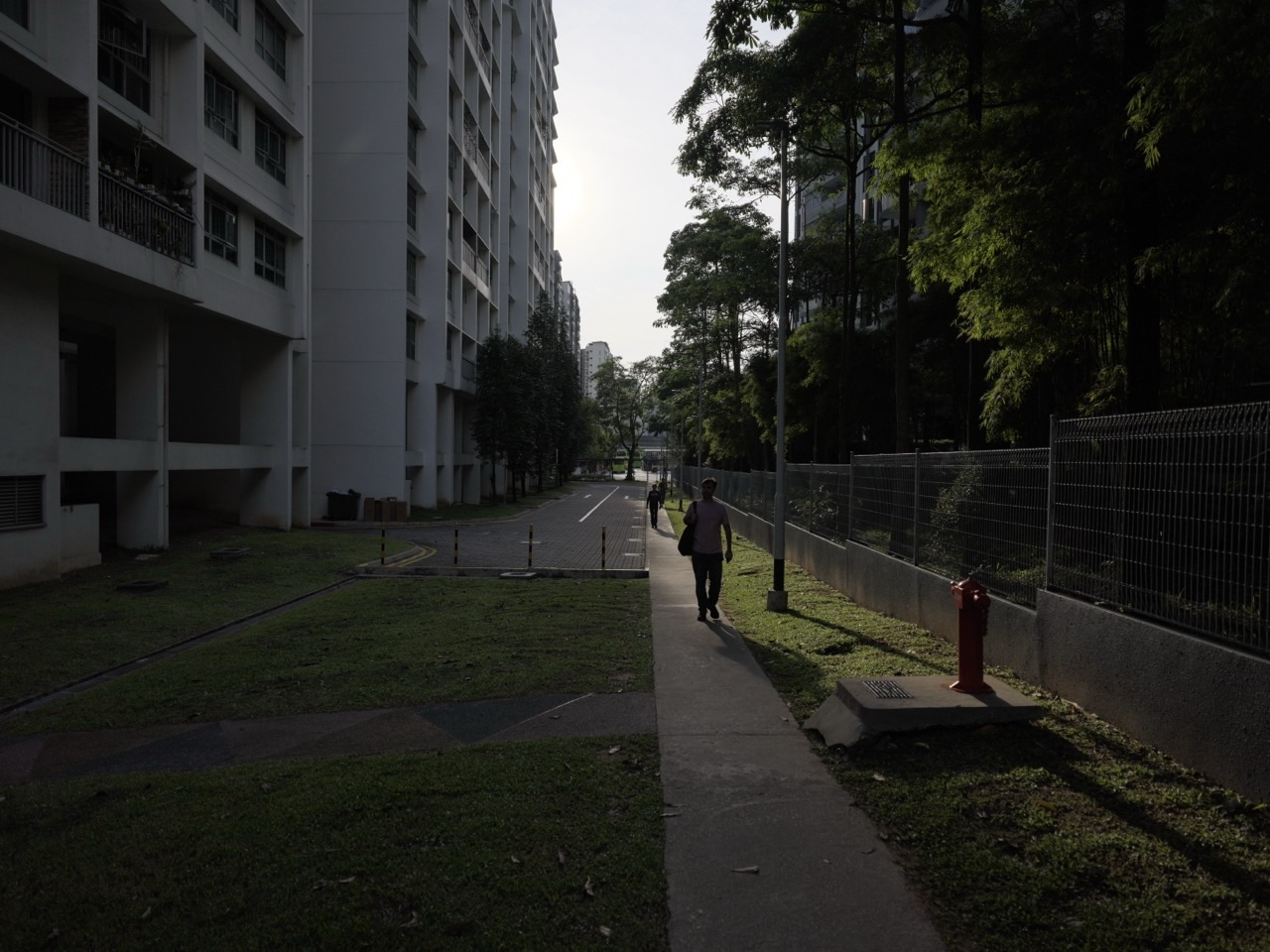 Punggol HDB blocks and a sidewalk behind Parc Centros condominium in Singapore