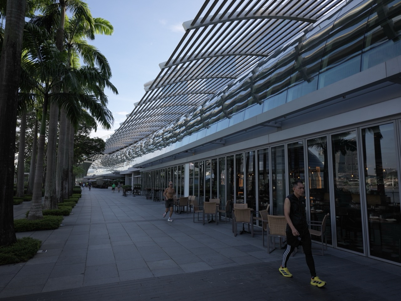 Runners on the waterfront promenade outside The Shoppes at Marina Bay Sands