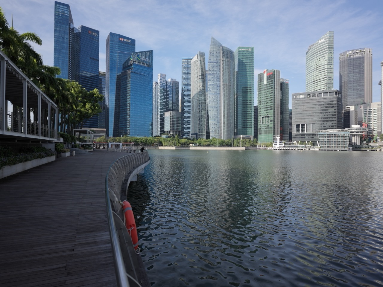 Waterfront promenade outside The Shoppes at Marina Bay Sands with the financial district skyline in the background