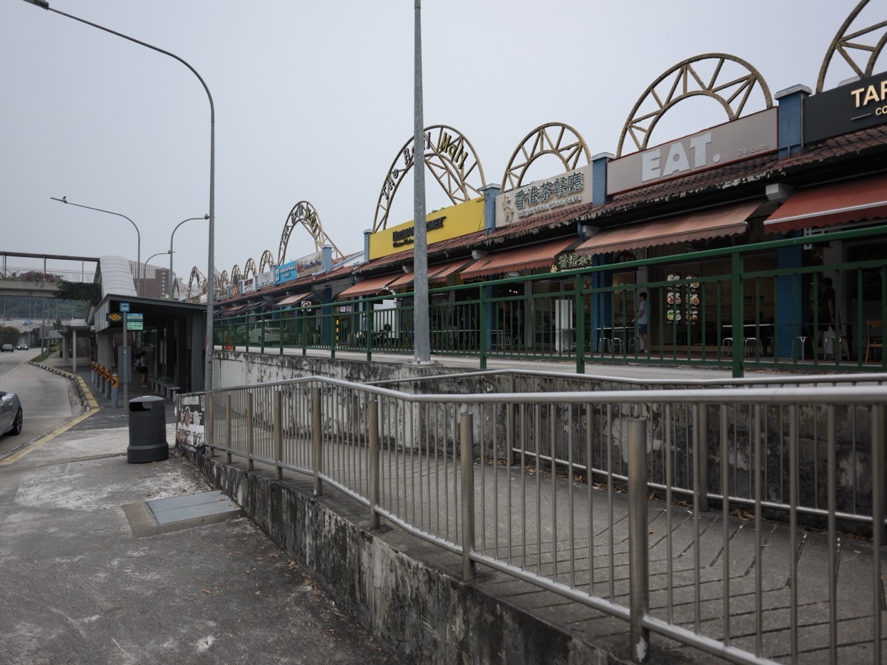 Shops at The Rail Mall with a nearby bus stop on Upper Bukit Timah Road in Singapore.