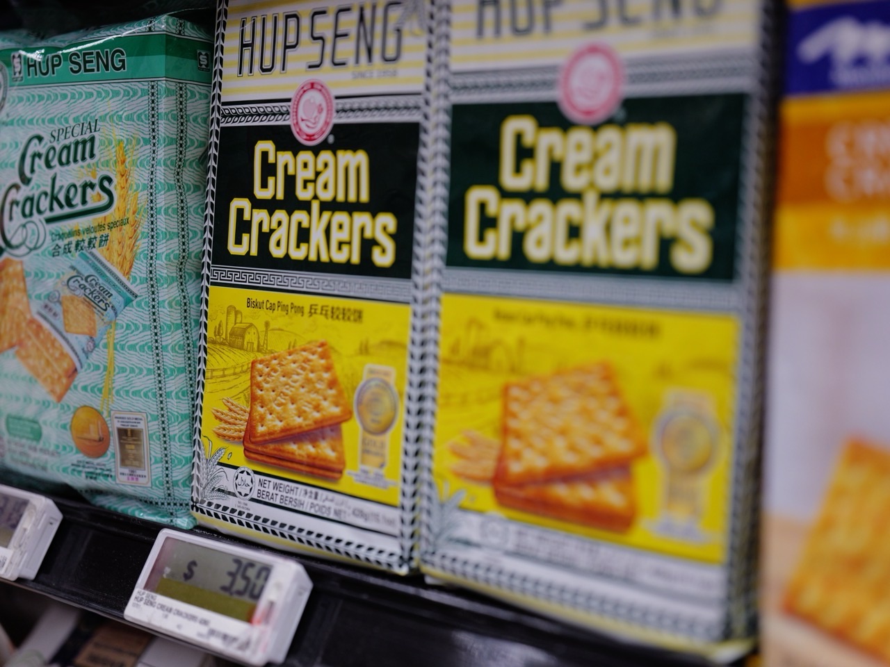 Cream crackers displayed on a supermarket shelf with a visible price tag.