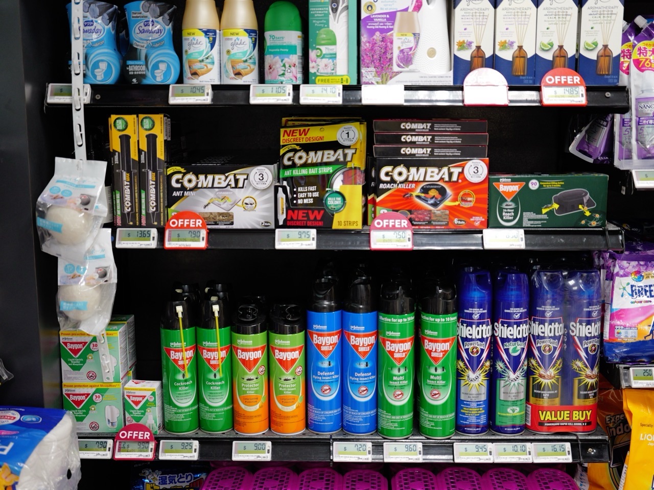 Household insecticide products displayed on a supermarket shelf.