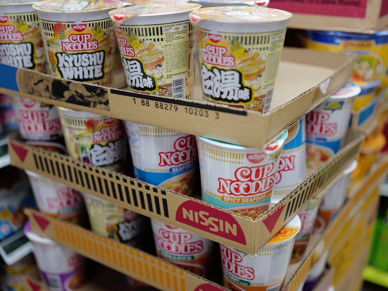 Stacks of instant noodles displayed in a supermarket.