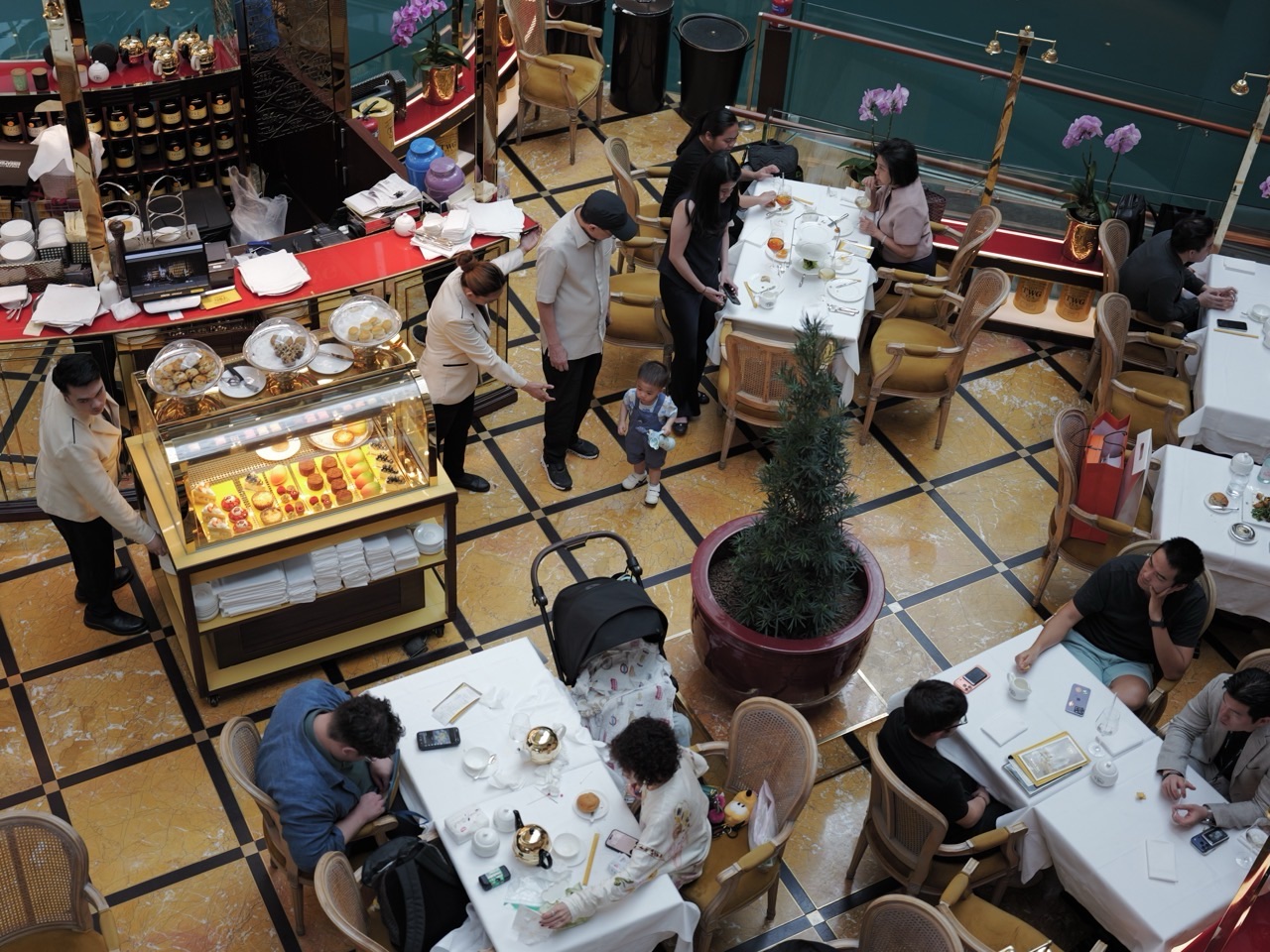 A family with children at a Marina Bay Sands restaurant during tea time, viewed from above.
