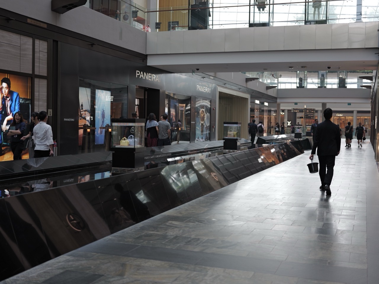 Shoppers walking along an indoor corridor at The Shoppes at Marina Bay Sands.