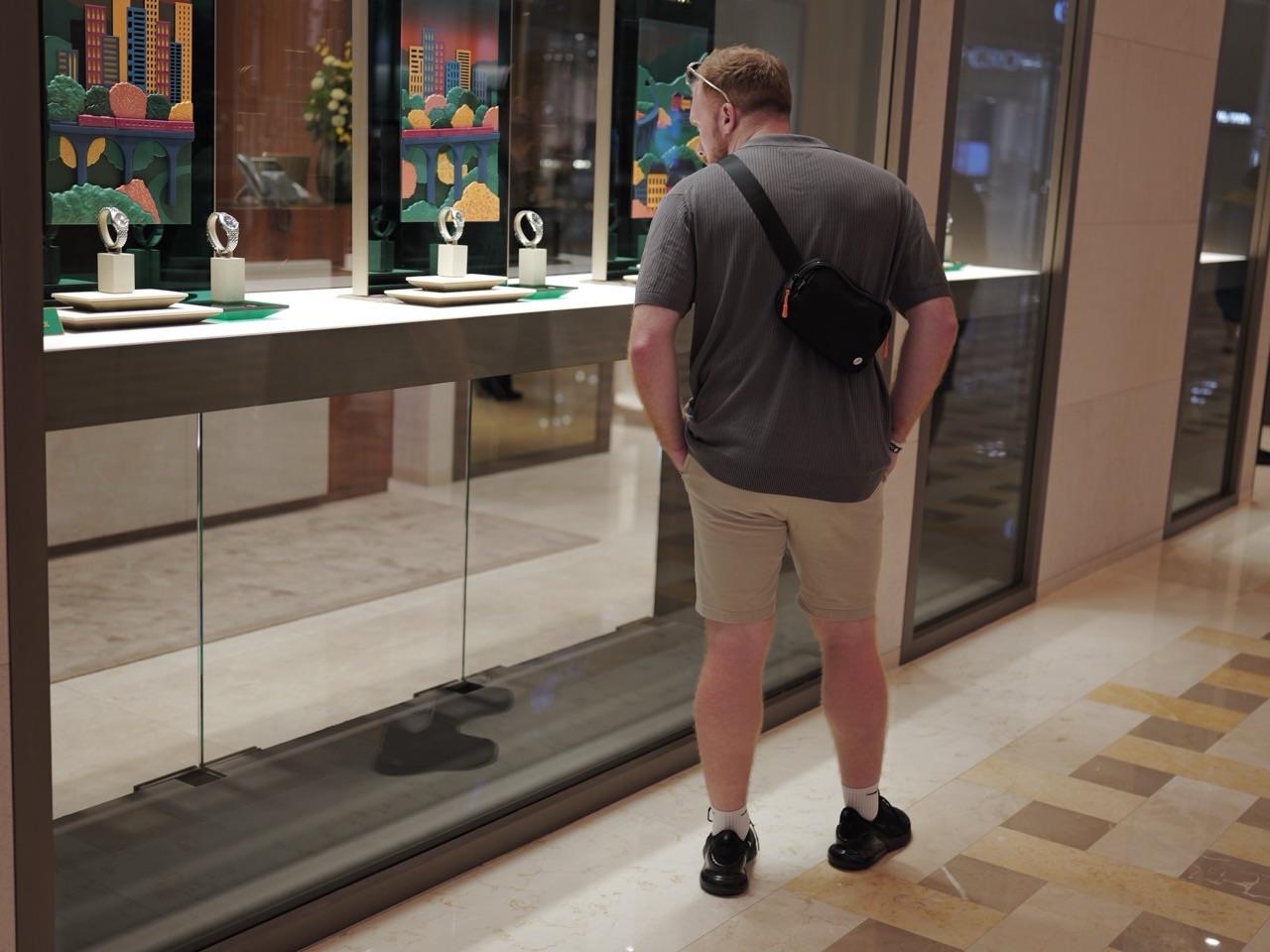 A shopper browsing a watch-store window at The Shoppes at Marina Bay Sands, Singapore.