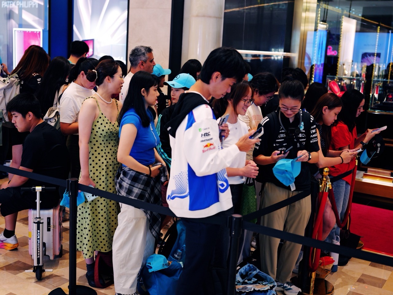 Visitors waiting in line for a Mercedes Formula 1 shop event at Marina Bay Sands, Singapore.