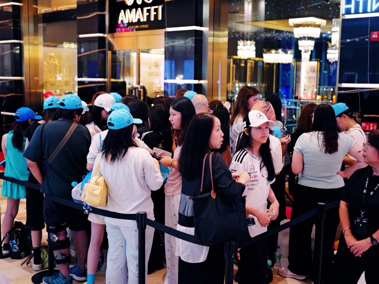 Visitors queueing outside a shop for a Mercedes Formula 1 event at The Shoppes at Marina Bay Sands.