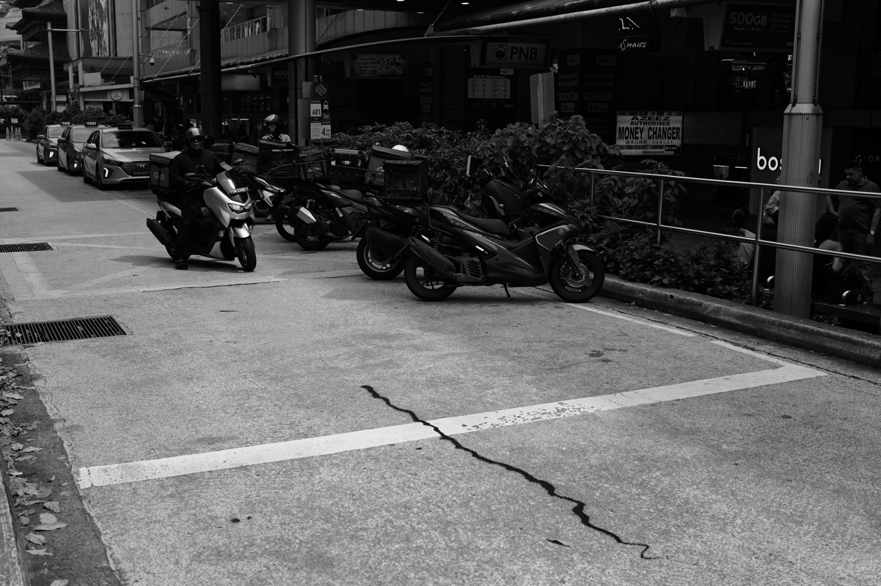 Bicycles parked along a side road in Singapore.
