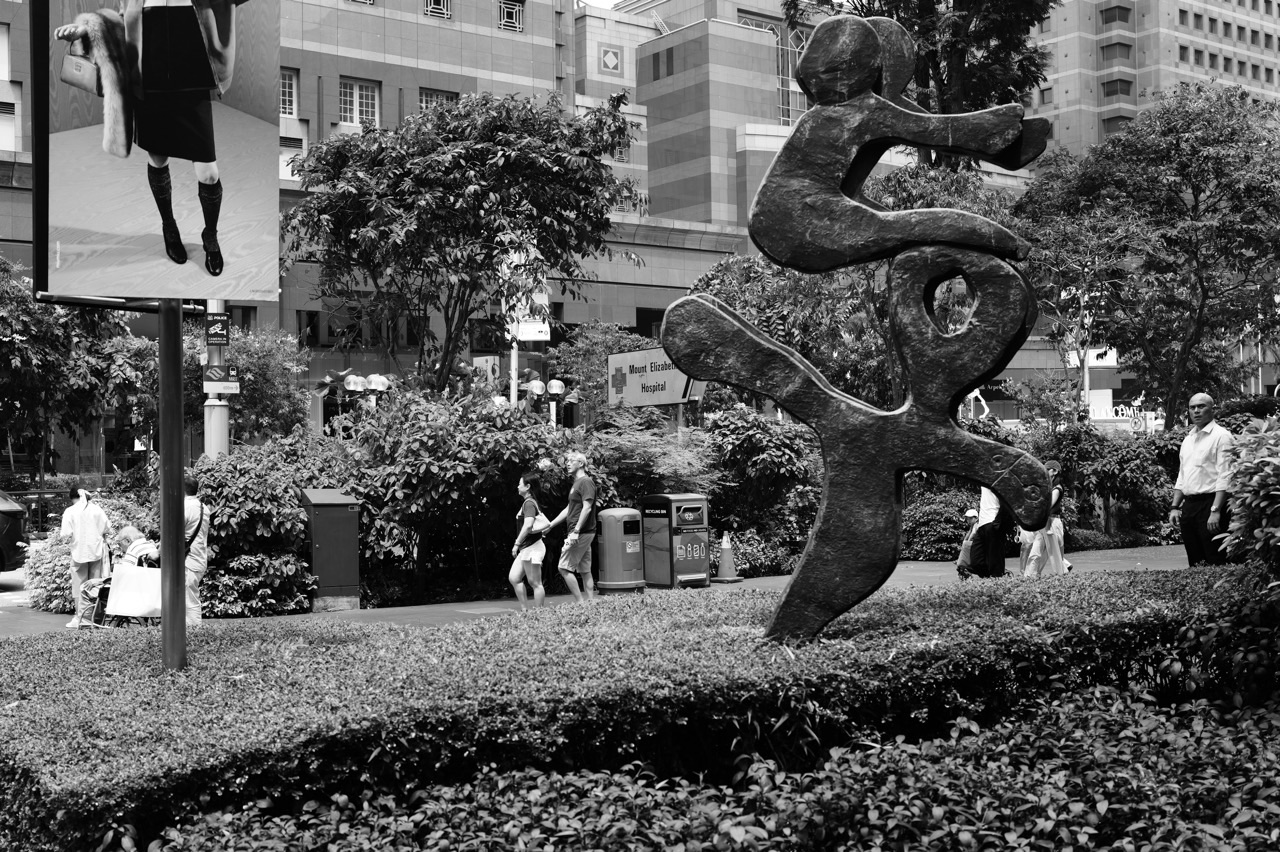 Art installation and pedestrians on Orchard Road near Ngee Ann City and Paragon in Singapore.