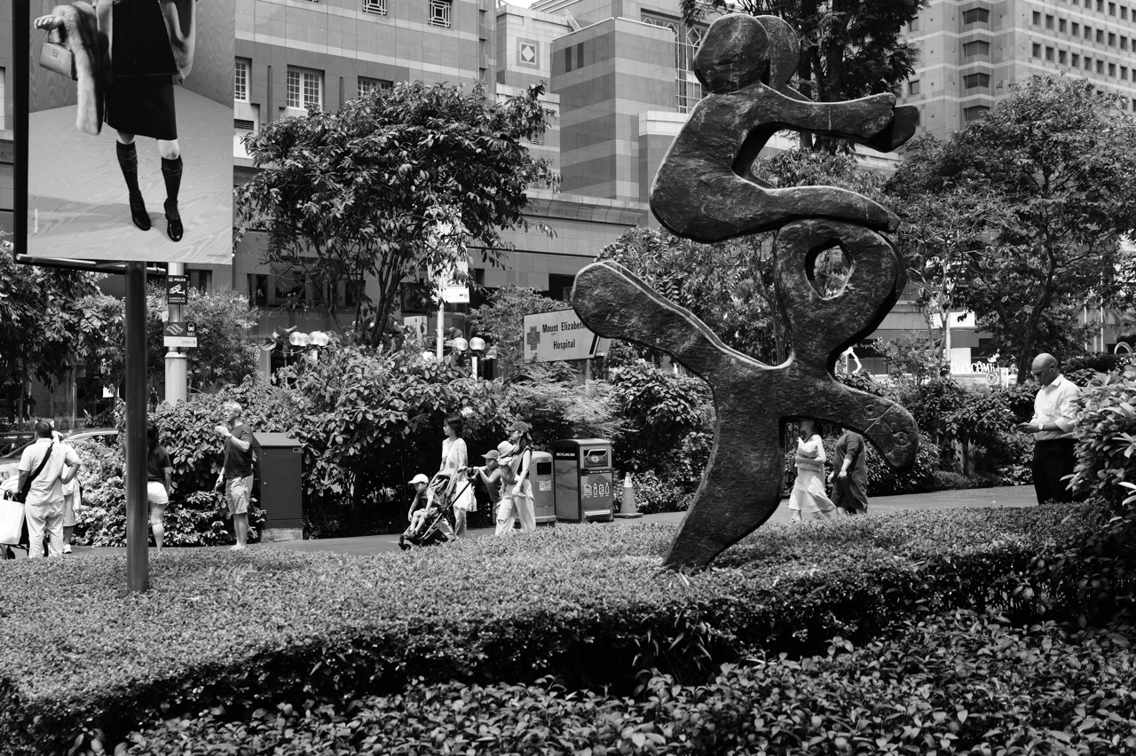 Art installation outside Paragon with families and baby strollers on Orchard Road in Singapore.