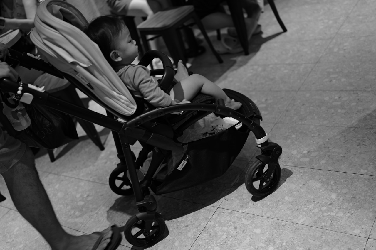 Young child seated in a stroller in Singapore.