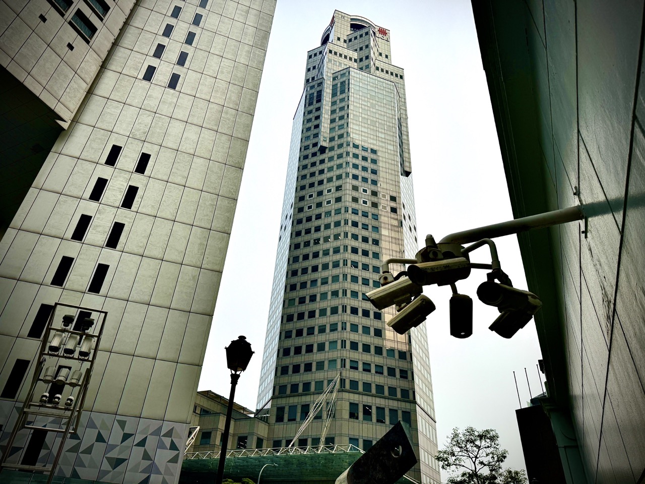 Raffles Place Park with the architecture of a UOB building rising nearby.