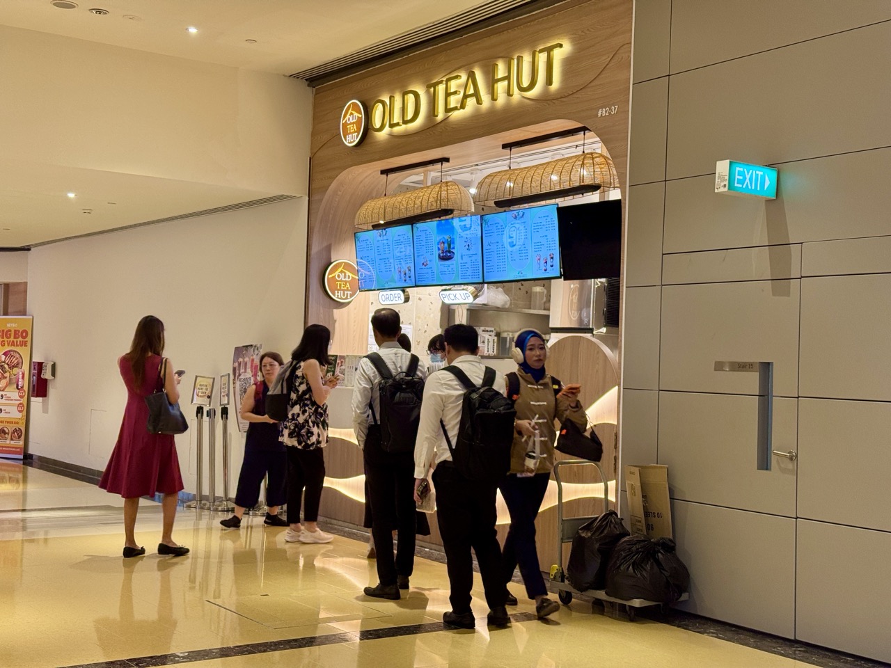People queuing to collect tea in an underground area of Singapore's Marina Bay financial district.