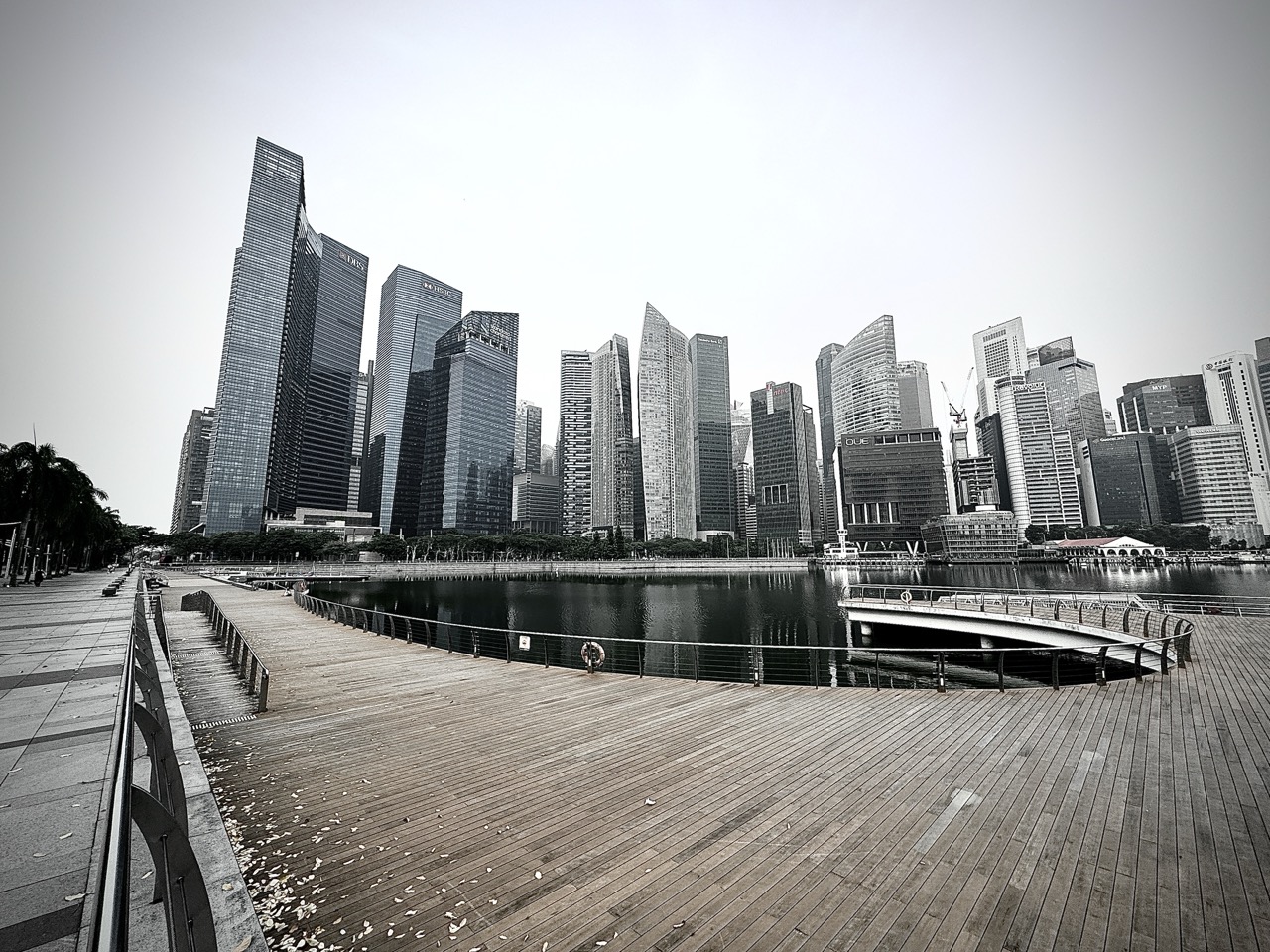 View of the Marina Bay financial district skyscrapers from the Marina Bay Sands boardwalk.