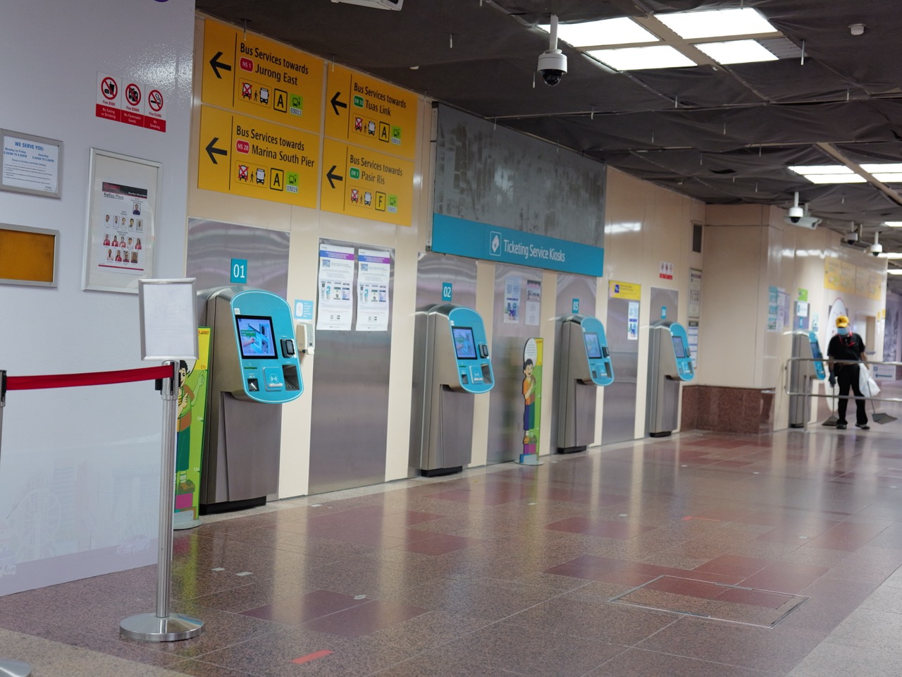 Self-service ticketing and service kiosks at Raffles Place MRT station in Singapore.