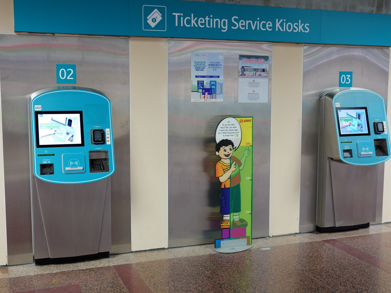 Row of ticketing-service kiosks at Raffles Place MRT station.