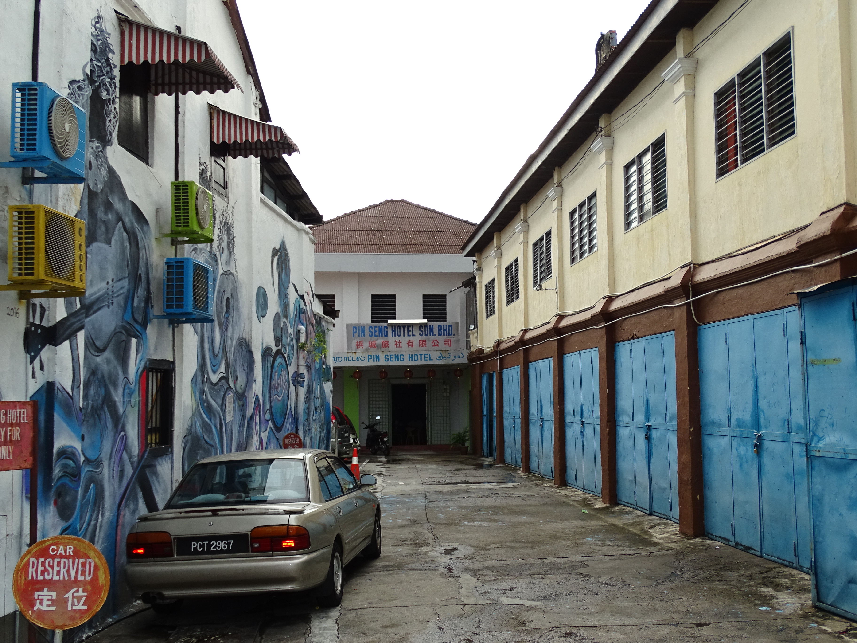 Historic George Town Penang street scene in Malaysia with local buildings and pedestrians, showing the setting for planning tourism during haze